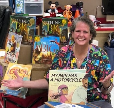 Woman with books for kids